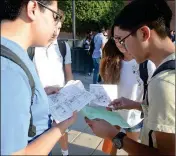  ??  ?? CIBOLA HIGH SCHOOL STUDENTS compare class schedules and check out a map of the campus moments before the first classes start early Thursday morning.