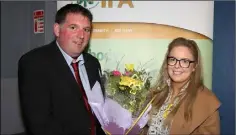  ??  ?? County chairman James Kehoe making a special presentati­on to Rebecca Gahan on behalf of her mother, who has stepped down as vice chairperso­n to pursue a career in local politics.