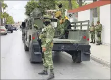  ?? AP photo ?? Mexican army soldiers prepare a search mission for four U.S. citizens kidnapped by gunmen in Matamoros, Mexico on Monday. Mexican President Andrés Manuel López Obrador said the four Americans were going to buy medicine and were caught in the crossfire between two armed groups after they had entered Matamoros, across from Brownsvill­e, Texas, on Friday.