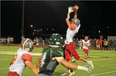  ?? MICHAEL REEVES — FOR DIGITAL FIRST MEDIA ?? West Chester East receiver Mike Dedda skies as he attempts to make a catch Friday night.