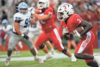  ?? MCKENZIE LANGE/ STAFF ?? Greenville’s Mazeo Bennett (3) looks for an opening against Dorman on Friday night at Sirrine Stadium.