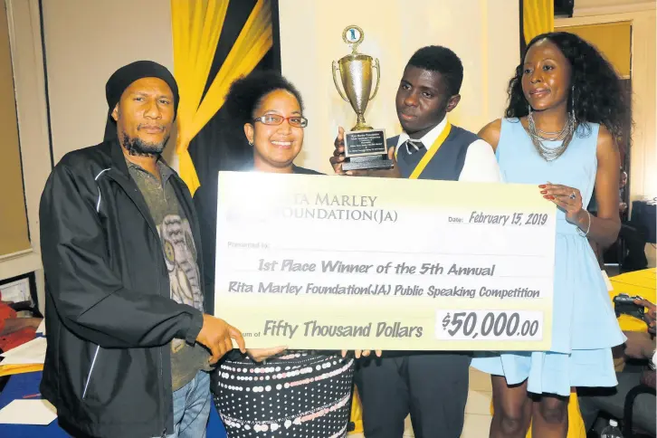  ??  ?? From left: Dr K’adamawe K’nife (judge), Ms Sharayne Bennett (teacher/coach), Fabian Morris (winner), Rosemary Duncan (manager, Rita Marley Foundation).