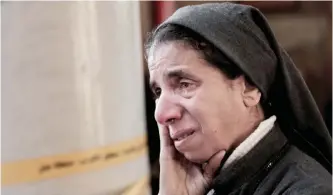  ??  ?? CAIRO: An Egyptian Coptic nun weeps as she looks at damage inside the St Mark Cathedral in central Cairo, following a bombing. —AP