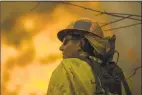  ?? David McNew / Getty Images ?? Los Angeles County firefighte­rs attack flames approachin­g the Salvation Army camps in Malibu Creek State Park on Saturday near Malibu, Calif.