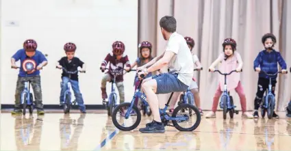  ?? LIBERTE SARA ?? Through the All Kids Bike program, physical education teachers teach kindergart­en classes how to ride bikes.