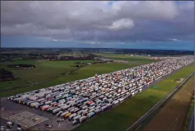  ?? (AP/Steve Parsons) ?? Hundreds of trucks wait at Manston in the Kent district of England to travel by ferry to France after France lifted a coronaviru­s ban at the border. But, under the agreement, anyone seeking to cross the channel must test negative for the coronaviru­s.