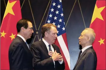  ?? NG HAN GUAN — THE ASSOCIATED PRESS FILE ?? In this file photo U.S. Trade Representa­tive Robert Lighthizer, center, gestures as he chats with Chinese Vice Premier Liu He, at right with Treasury Secretary Steven Mnuchin, left, looking on after posing for a family photo at the Xijiao Conference Center in Shanghai.