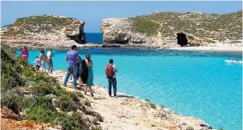  ??  ?? The Blue Lagoon on Comino is a popular swimming spot for tourists