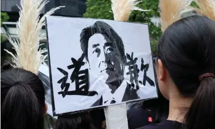  ?? ?? NGO group members in 2018 display a placard showing Japan’s then prime minister, Shinzo Abe, and the text ‘Apologise’ during a rally in Taipei for ‘comfort women’. Photograph: Sam Yeh/AFP/Getty Images