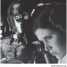  ?? 20th Century Fox ?? Carrie Fisher as Princess Leia with C3PO in the 1977 release of “Star Wars.”