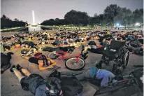  ?? JOEY ROULETTE • REUTERS ?? Demonstrat­ors lie down during a protest against racial inequality in the aftermath of the death in Minneapoli­s police custody of George Floyd at the Lincoln Memorial in Washington, U.S., June 6.