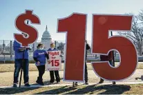  ?? J. Scott Applewhite / Associated Press ?? Activists appeal for a $15 minimum wage in Washington on Feb. 25. The current federal minimum wage is $7.25 an hour, or $290 for a 40-hour workweek.