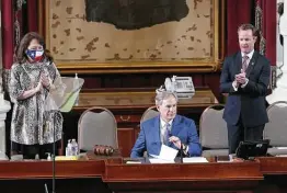  ?? Photos by Kin Man Hui / Staff photograph­er ?? Gov. Greg Abbott listens as his wife, Cecilia, and newly elected House Speaker Dade Phelan join the applause during the convening of the 87th Texas Legislatur­e in Austin.