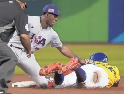  ?? JOE RONDONE/THE REPUBLIC ?? Team USA’s Tim Anderson tags out Colombia’s Oscar Mercado at second base on an attempted steal during their World Baseball Classic game at Chase Field on Wednesday in Phoenix.