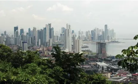  ?? PAUL MARSHMAN FOR THE TORONTO STAR ?? The rainforest is never far away from Panama City’s fast-growing urban skyline. With the canal expansion, the city is attracting foreign business.