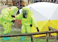  ??  ?? British investigat­ors in protective suits at the crime scene in Salisbury. Reuters/Peter Nicholls