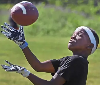  ?? Peter Diana/Post-Gazette ?? THE NEXT GENERATION Mekhi Jackson of Altoona hauls in pass while running drills at the Steelers Youth Football Camp on Friday at California University of Pa.