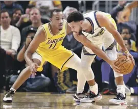  ?? Ezra Shaw Getty Images ?? AVERY BRADLEY of the Lakers guards Golden State’s Stephen Curry during a game in October. Bradley will not rejoin the team for the NBA restart in Florida.
