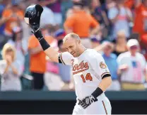  ?? GAIL BURTON/ASSOCIATED PRESS ?? Oriole Nolan Reimold tips his helmet after hitting a walk-off two-run home run against Cleveland on Sunday.