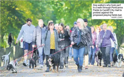  ?? MARK LEWIS ?? Dog walkers who took part in a walk through Pontcanna Fields to Cardiff City Hall to protest against the proposed playing fields ban