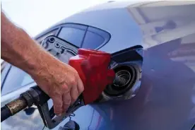  ?? ?? A customer pumps gas at an Exxon gas station in Miami. Photograph: Marta Lavandier/ AP