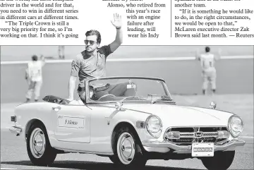  ??  ?? Alonso waves to fans during the drivers’ parade ahead of the Formula One Japanese Grand Prix at Suzuka in this Oct 8 file photo. — AFP photo