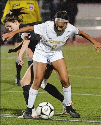  ?? DANA JENSEN/THE DAY ?? Stonington’s Vanessa Benjamin (2) and Montville’s Michaela MacCracken (13) fight for control of the ball during Thursday night’s Eastern Connecticu­t Conference Division II girls’ soccer tournament title game at Montville High School. The Bears won the program’s first conference title with a 1-0 victory over the Indians. Visit www.theday.com to view a photo gallery.