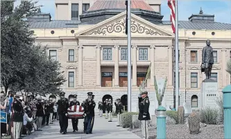  ?? JUSTIN SULLIVAN GETTY IMAGES ?? Military honour guards carry the casket of U.S. Sen. John McCain from the Arizona State Capitol to go to a memorial service at the North Phoenix Baptist Church Thursday in Phoenix.