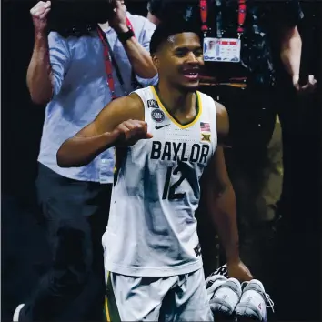  ?? DARRON CUMMINGS — THE ASSOCIATED PRESS ?? Baylor guard Jared Butler (12) celebrates as he walks off the court at the end of a men’s Final Four NCAA college basketball tournament semifinal game against Houston, Saturday at Lucas Oil Stadium. Baylor won 78-59.