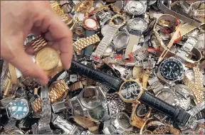  ??  ?? View of fake Swiss watches, seized during spot checks of goods to be imported, exported or in transit, before they were destroyed on request by the Federation of the Swiss Watch Industry at a recycling plant in Cressier.