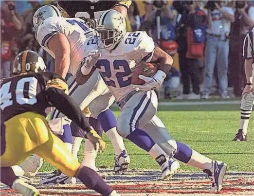  ?? ASSOCIATED PRESS ?? Cowboys running back Emmitt Smith works for a long gain of 23 yards against the Steelers, but was held to 49 rushing yards overall by Pittsburgh’s defense in Super Bowl XXX.