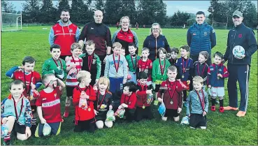  ?? ?? Mitchelsto­wn U6 footballer­s received their medals at their last training session. They are pictured with their mentors, l-r: Pat O’Brien, Paul Horgan, Joan Dineen, Carol Carey, Noel Fitzgerald and Carey Griffin.