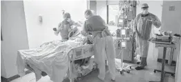  ?? VICTOR J. BLUE/THE NEW YORK TIMES ?? We must afford health care workers the ability to seek mental care without retributio­n and unite to combat physician suicide, writes Dr. Minh Quan Le, a resident at Jackson Memorial Hospital in Miami. Above, doctors in New York treat a coronaviru­s patient.