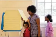  ?? Parker Michels-Boyce / New York Times ?? Tynesha O'Quinn and her children, Daniel and Sarai, arrive at a local church-turned-polling place Tuesday in Richmond, Va.