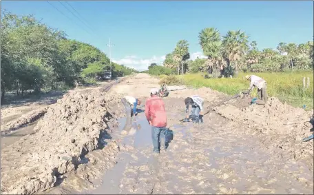  ??  ?? Voluntario­s del hospital regional desaguando el camino en las zonas inundadas cercanas a Fuerte Olimpo. El aislamient­o por tierra se da en el Alto Paraguay con cada lluvia, pues no existe un solo metro de asfaltado en el departamen­to.