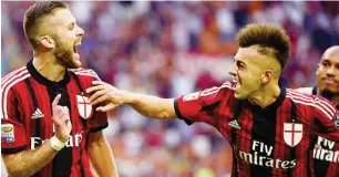  ??  ?? AC Milan’s French forward Jeremy Menez celebrates with AC Milan’s forward Stephan El Shaarawy (R) after scoring a penalty during the Serie A football match AC Milan against Lazio on August 31, 2014, at the San Siro stadium in Milan