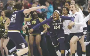  ?? The Associated Press ?? NATIONAL CHAMPS: Notre Dame’s Arike Ogunbowale (24) is congratula­ted by teammate Jessica Shepard (23) after sinking a 3-point basket to defeat Mississipp­i State, 61-58, in the championsh­ip game of the NCAA Tournament Sunday in Columbus, Ohio.