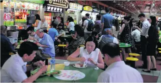  ?? Munshi Ahmed for The National ?? Three quarters of Singaporea­ns eat at hawker centres at least once a week.