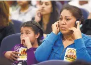  ??  ?? Olga Hernandez, a native of Mexico, and her 9-year-old daughter, Valeria Hernandez, listen to the debate on the “immigrant-friendly” resolution on Monday.