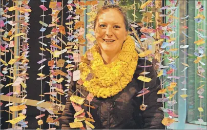  ?? DAVID JALA/CAPE BRETON POST ?? Robyn Neal stands among the ticket-like leaves that hang from her Money Tree artwork that attracted lot of attention from people attending the sixth annual Lumiére festival. The Coxheath artist said her piece was inspired by the Cape Breton’s recent...