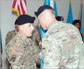  ?? SUMBITTED ?? Major Gen. Gary W. Johnston, left, commanding general for U.S. Army Intelligen­ce and Security Command, receives the guidon from Lt. Gen. Scott D. Berrier, U.S. Army deputy chief of staff, G-2, during the INSCOM change of command ceremony at the Fort...