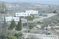  ?? (Marc Israel Sellem/The Jerusalem Post) ?? MOTHER AND CHILD go for a walk at the Amona outpost in the Binyamin region of Samaria last Friday.