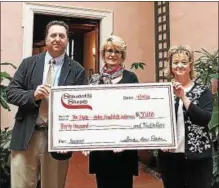  ?? PHOTO PROVIDED ?? Mike Harran, senior district manager of Stewart’s Shops, and Sheri McGarr, district manager of Stewart’s, right, present Hyde Collection Interim Director Anne Saile, center, with a $30,000 gift from Stewart’s and the Dake family.