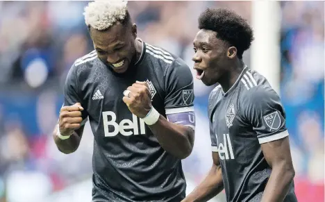  ?? DARRYL DYCK/THE CANADIAN PRESS ?? The Whitecaps’ Alphonso Davies, left, seen celebratin­g a goal with teammate Kendall Waston, has many reasons to smile these days. He will join the Bundesliga’s Bayern Munich next year as part of an MLS-record $22-million transfer deal.