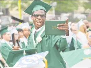  ?? Alex von Kleydorff / Hearst Connecticu­t Media ?? Above, Raekwon Fulton heads down the aisle with his new diploma during graduation with the Norwalk High School class of 2018 during commenceme­nt exercises on Monday. Below, Stephanie Zavala is all smiles at graduation with the Norwalk High School.