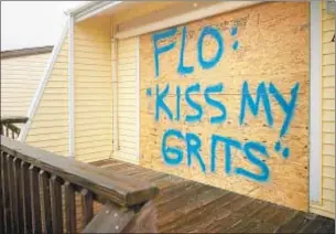  ?? GETTY IMAGES ?? Sign defies Florence, but owner of property in Atlantic Beach, N.C., did the right thing by boarding up and heading out.