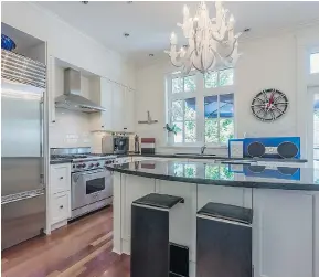  ??  ?? An open concept makes the wonderfull­y appointed kitchen in Kitsilano’s 2568 Vine St. feel brighter and bigger than it is.