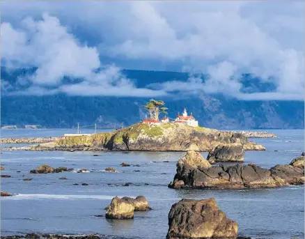  ?? Photograph­s by Allen J. Schaben Los Angeles Times ?? THE SUNSET illuminate­s Battery Point Lighthouse and sea stacks in Crescent City on California’s northern coast.