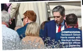  ?? ?? COMPASSION: Taoiseach Simon Harris meets with Stardust families outside his offices yesterday