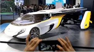  ?? — AP ?? A visitor takes a photo of the Aeromobil, a flying car from Slovakia, during the China Internatio­nal Import Expo in Shanghai on Monday.